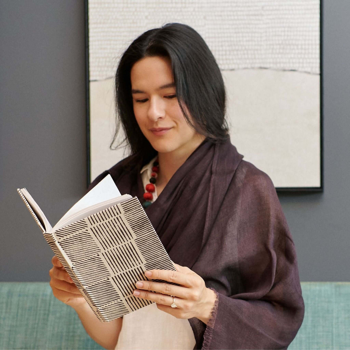Resin Dark Brown Hand Woven Soft Linen Silk Scarf worn while reading a book in a cozy setting.
