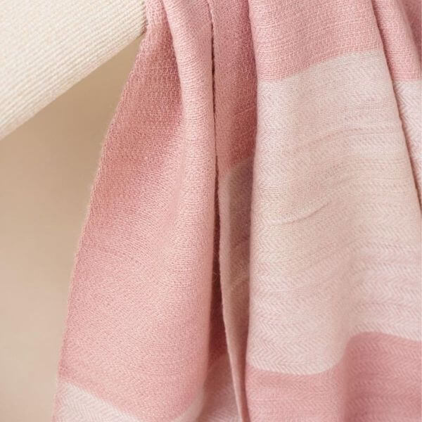 Rosa Plush Maroon Plush Merino Queen Bedspread / Large Throw showcasing soft pink herringbone weave on display.