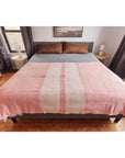 Rosa Plush Maroon Plush Merino Queen Bedspread / Large Throw displayed on a bed, featuring modern design and soft colors.