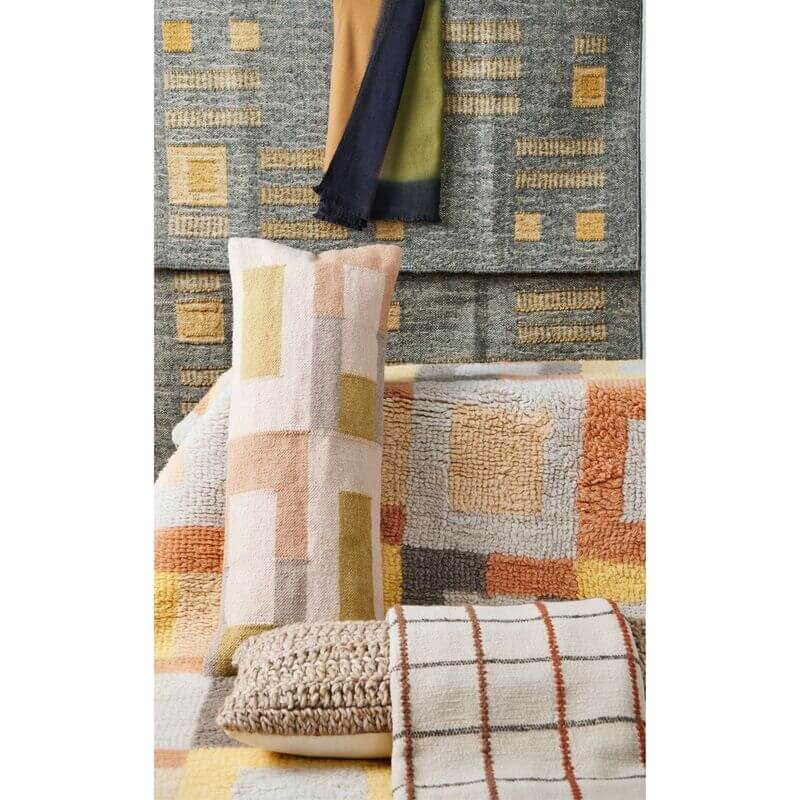 Shale Hand Woven Pastel Color Large Geometric Lumbar Pillow displayed among colorful decor and textiles.