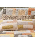 Shale Hand Woven Pastel Color Large Geometric Lumbar Pillow displayed on a cozy textured blanket.