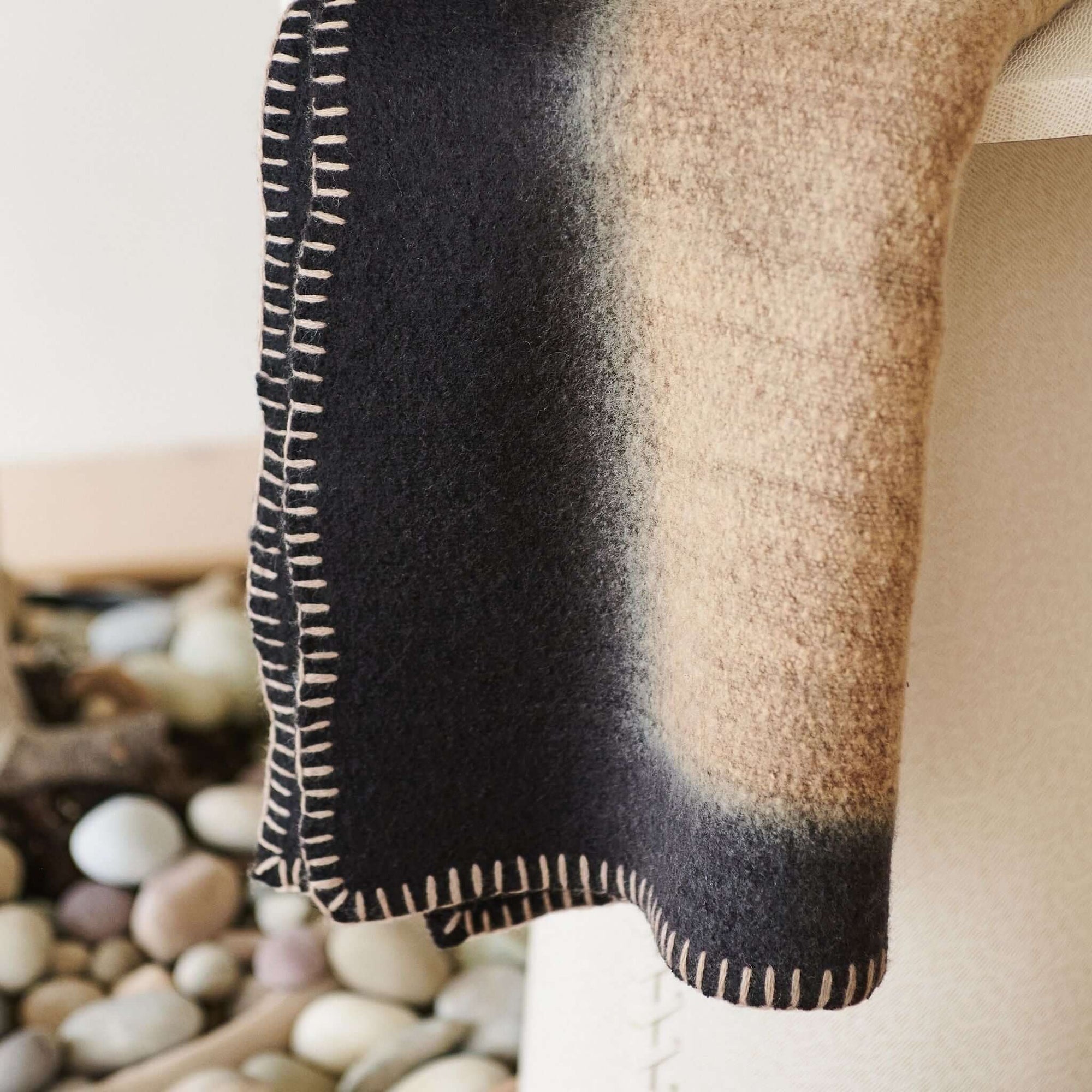 Siro Brown Handwoven Merino Artisan Throw Blanket showcasing intricate stitched detailing and a gradient design.