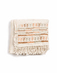 Unah Coral Hand Embroidered Handwoven Cotton Artisan Throw folded with colorful embroidered borders and fringes.